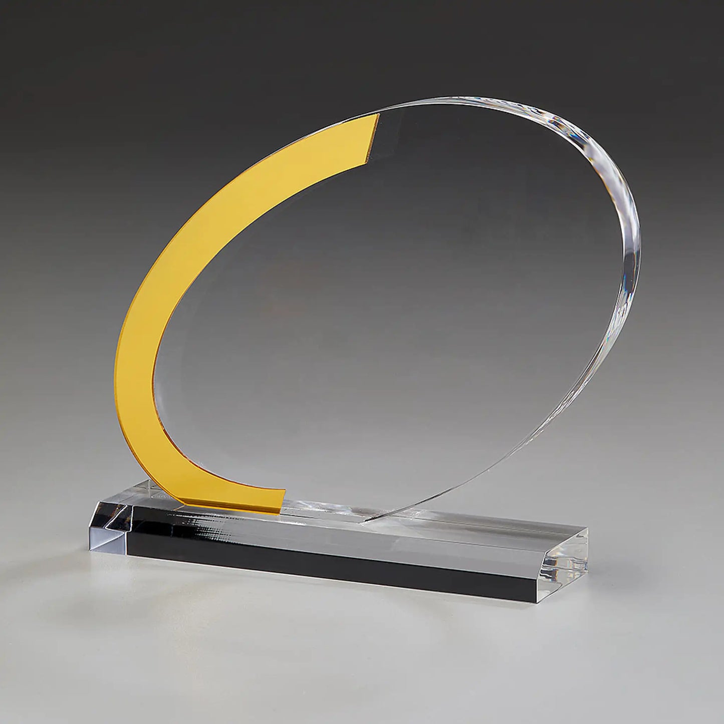 Dynamic Award aus klarem Acrylglas, Seitenansicht – goldfarbenes C-Element auf klarem Acrylsockel, hier ohne Gravur